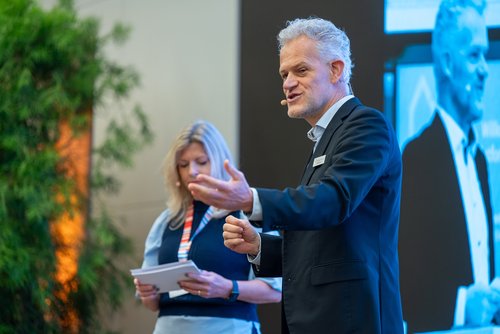 Das Foto zeigt Frank Hettler, Leiter von Zukunft Altbau, auf der Bühne beim Herbstforum Altbau 2025.